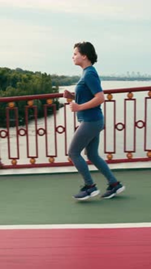 Woman Running on Bridge for Fitness and Health
