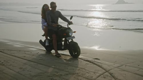 Happy Couple Ride Motorbike Stop on Seaside at Sunrise Man Woman in Love Slows Down on Motorcycle on