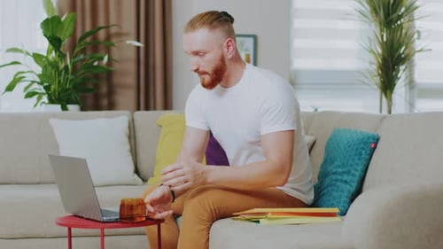 Young Man Working on Laptop at Home