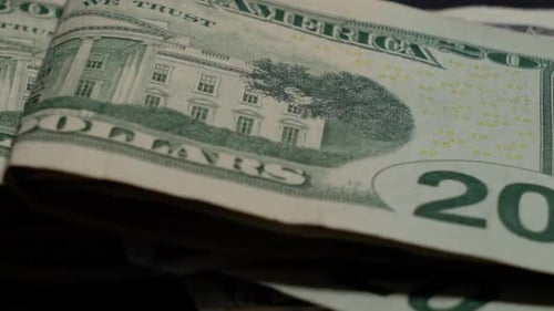 Rotating twenty dollar USD bill folded on black background, Closeup