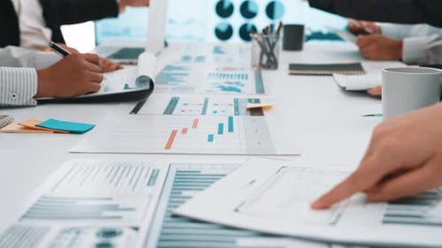 Business Team Analyzes Data Charts in Modern Office