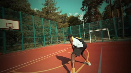 An Exciting Dynamic Basketball Jump Shot is in Action on an Outdoor Basketball Court
