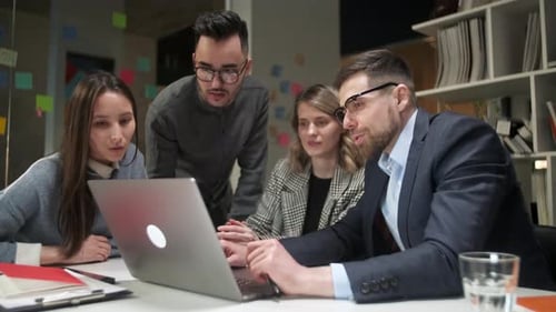 Colleagues And Clients Talking Strategy With Laptop And Tablet In Creative Office Productive