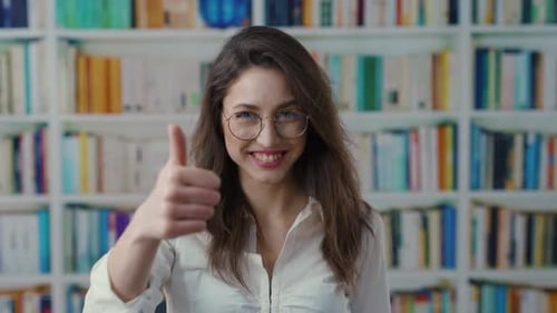 A Woman Explores Books in a Library Sharing Her Reviews Visually