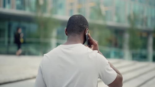 African American Guy Talking on Phone Standing on Street Back to Camera Man Calling Smartphone