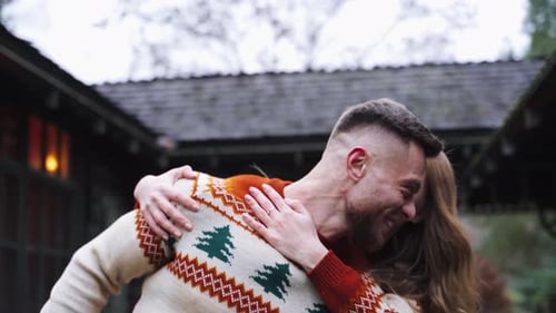 Happy couple having fun. Romantic couple in warm sweaters enjoying time together outdoors.