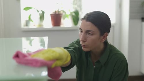 Woman Cleaning Table with Spray and Cloth