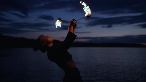 Professional Stuntwoman Performing Tricks On Fire Show Slow Motion Portrait In Darkness