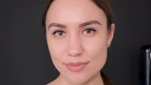 Portrait of a Beautiful Brunette Model Looking at the Camera Close Up