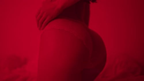 Sensual woman hips in sexy panties and lingerie posing on bed at night