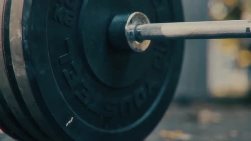A CloseUp View of Heavy Weightlifting Equipment and a Barbell in Action at the Gym