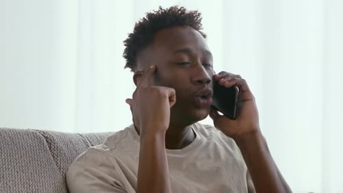Emotional Black Guy Quarreling on Cellphone at Home