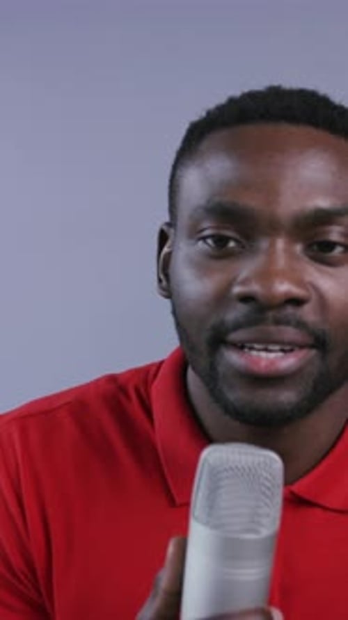 Man Holding Microphone and Speaking for Broadcast