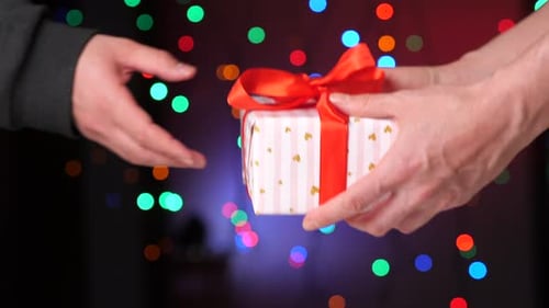 Giving a Christmas Gift with Bokeh Background