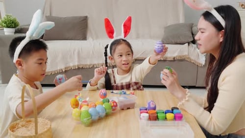 Family Painting Easter Eggs Together Indoors