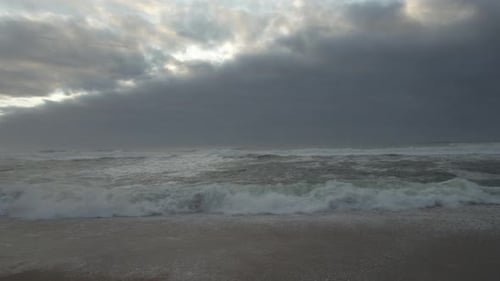 Aerial view crashing waves flowing on seashore rocks in a dark sea, ocean sea surface,Amazing sea