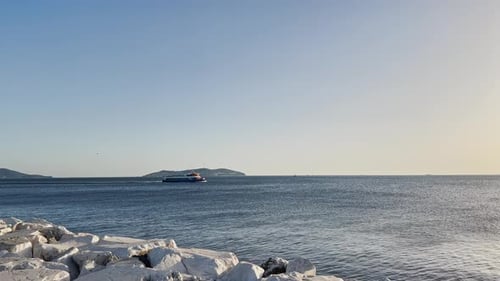 Ships passing by the sea at sunset on the beach