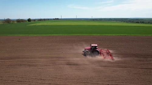 Aerial view of tractor tilling field, Bulgaria.