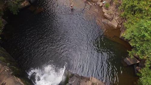 Man jumps in lake from waterfall into deep jungle. Great aerial view flight
thailand jungle Waterfa