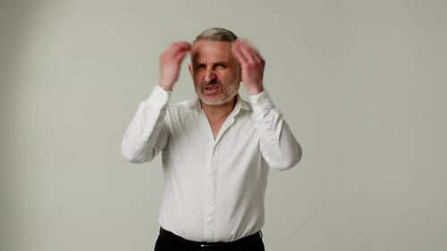 Stern Man Gesturing and Talking to the Camera