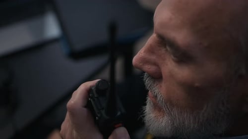 Security Officer Communicating via Two Way Radio during Surveillance