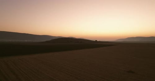 Scenic Aerial View of Rural Field at Sunrise