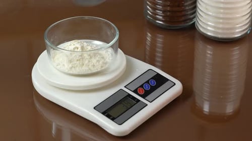 Measuring Flour in Bowl on Scale Close Up