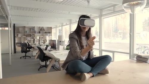 Woman wearing vr headset exploring virtual reality in modern canadian office