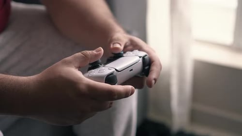 Close up of hands playing modern console video game