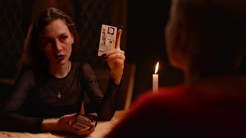 View From Back of Unrecognizable Client to Mysterious Fortuneteller Talking to Adult Woman About