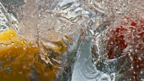 Colorful Peppers Plunging into Clear Water