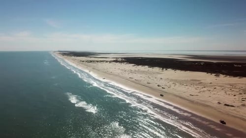 Aerial drone view as elevation decreases beach at low tide on a gulf coast barrier island on a sunny