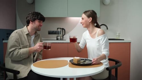 Happy Couple Sharing Tea and Cake in Kitchen