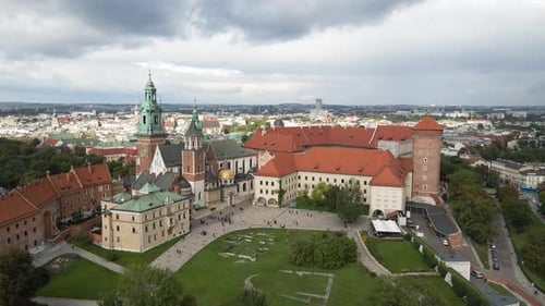 Cinematic aerial shot of historic buildings in Krakow Poland on an overcast day. Wawel Royal Castle