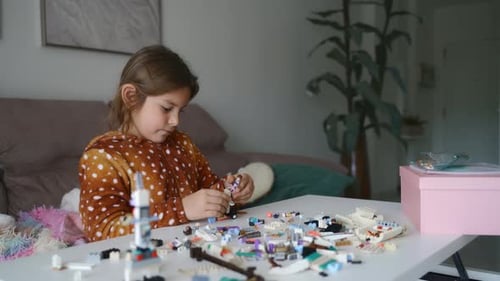 Young Girl Engaged in Creative Play with Colorful Building Blocks at Home