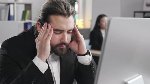 Male in Formal Suit Suffering From Headache at Office