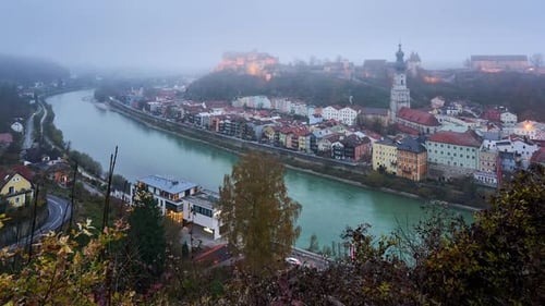 Burghausen timelapse in fog. The longest castle in the world illuminated at night. View from across