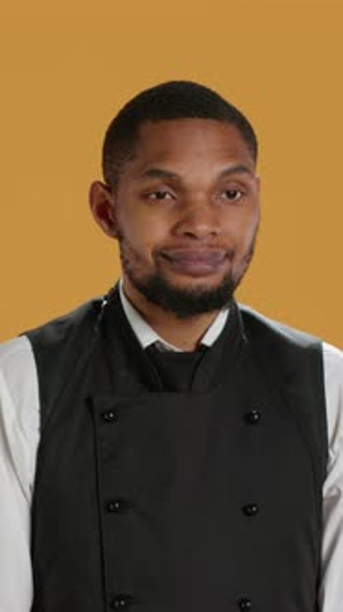 Vertical Video Portrait of Restaurant Waiter Wearing Professional Uniform and Apron