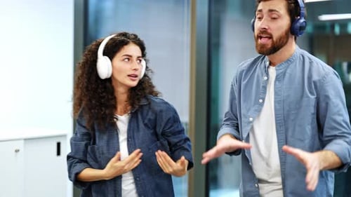 Happy Business Colleagues Enjoying Music During Office Break Dancing Together