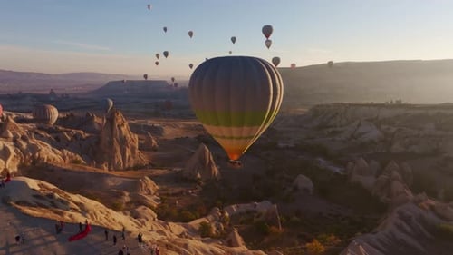 Goreme, Turkey - 01 December 2024: Aerial view of hot air balloons at sunrise, Turkey.