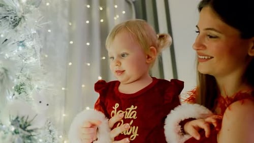 Family Enjoys Bright Holiday Moment Decorating Shimmering Christmas Tree Together with Cheer