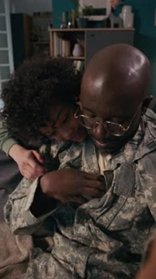 Soldier and Child Embrace in Home Interior