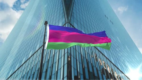 Realistic Waving Flag with Abstract Colors Against Corporate Skyscraper