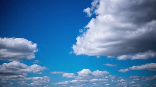 White Clouds Moving Slowly Across a Clear Blue Sky