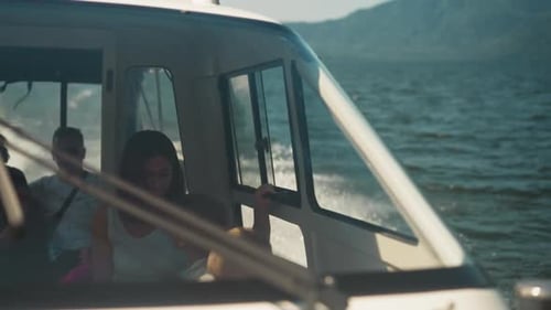 Passengers Group Sits in Cabin of Sailing Boat at Seaside