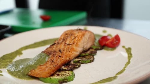 chef prepares a salmon dish in the kitchen. Close-up shots
