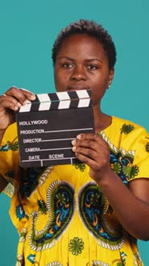 Vertical Video Young Woman Movie Producer Clapping Filming Slate to Cut a Scene