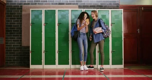 Girl friends, phone and school with laughing, meme and social media together by a locker