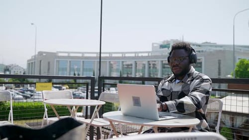 Man Working on Laptop at Urban Cafe
