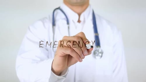 Doctor Writing the Word Emergency with Marker